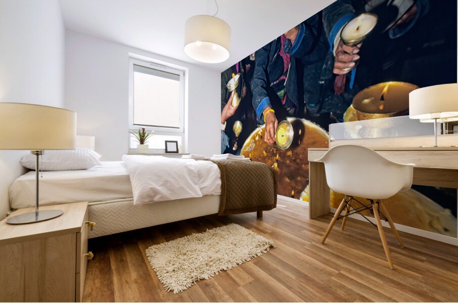 Lighting butter lamps during a ceremony in Tibet Mural print