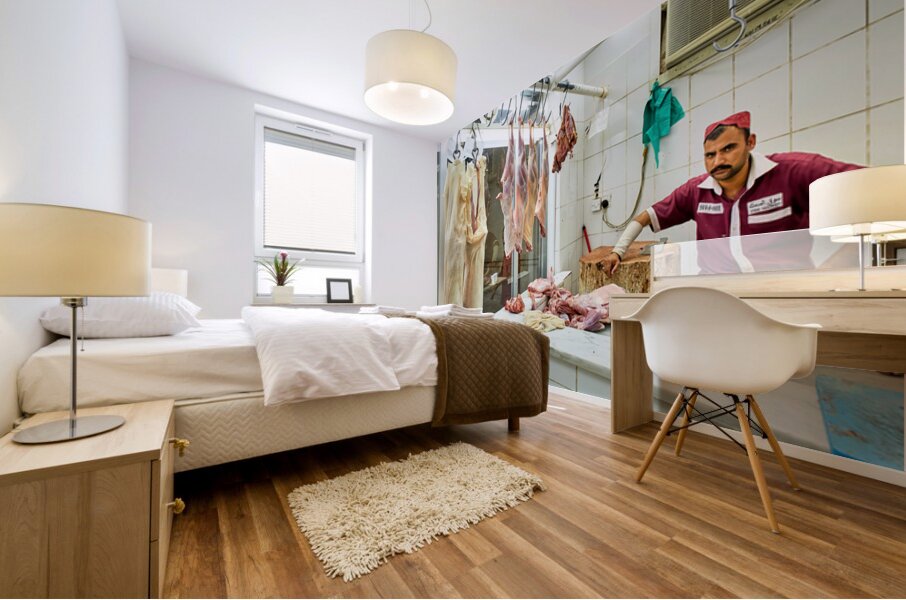 Butcher works in meat market in Dubai with hanging meat Mural print