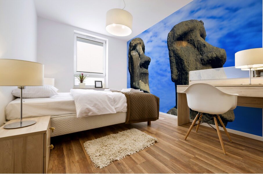 Two Moai statues against a blue sky. Mural print