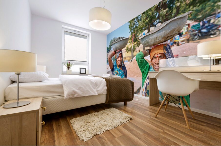 Women carry materials in Varanasi near the river bank Mural print