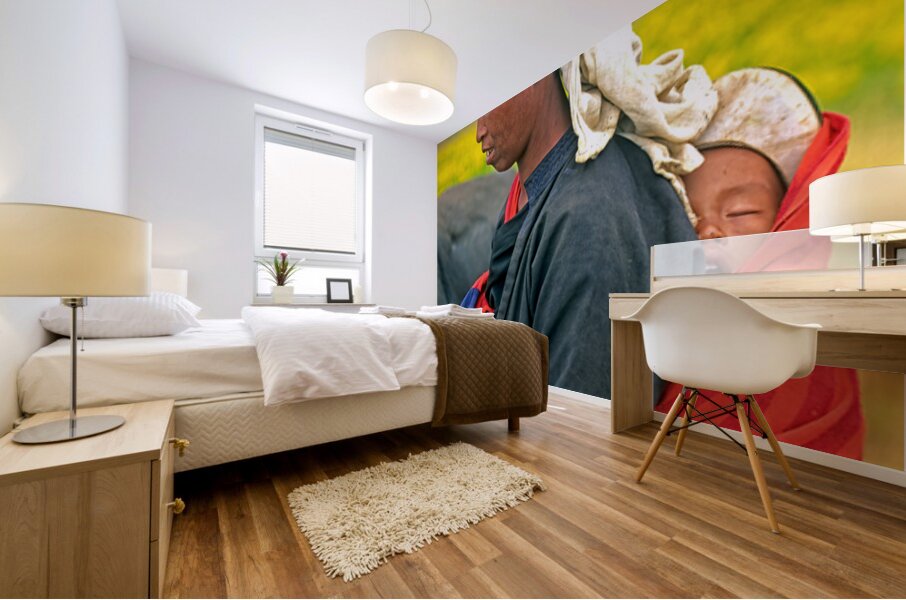 Woman carries son on her back in Myanmar fields Mural print