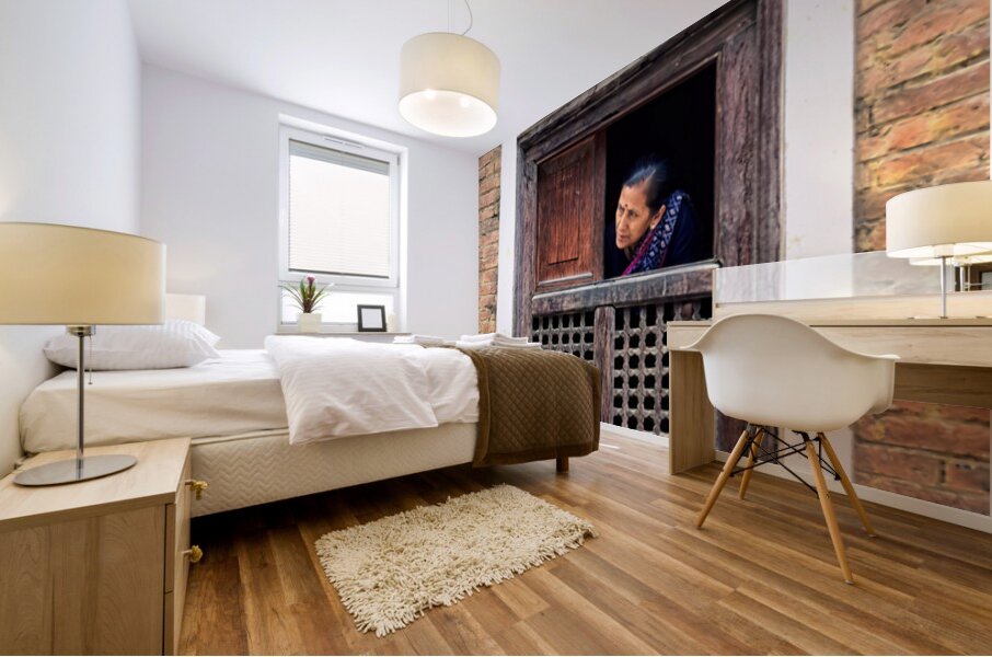 Woman in Kathmandu looks out from window in old building Mural print