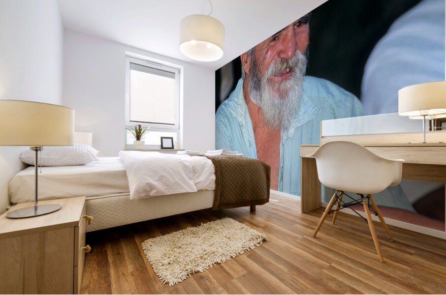 Elderly man smiles while sitting outdoors in Bukhara Uzbekistan Mural print