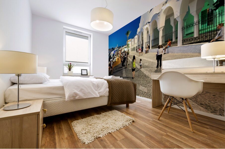 Santorinis iconic white church and bustling street at dusk. Mural print
