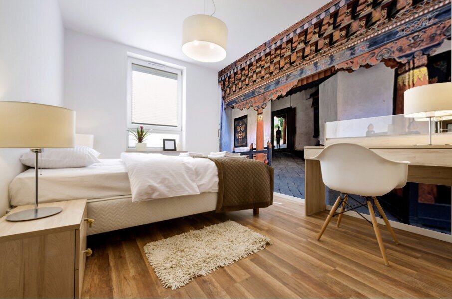 Intricate Bhutanese temple entrance with a person and fierce mas Mural print