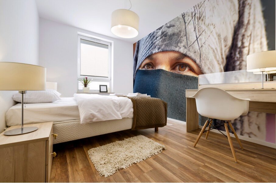 Veiled Moroccan woman in Marrakesh market on a sunny day Mural print