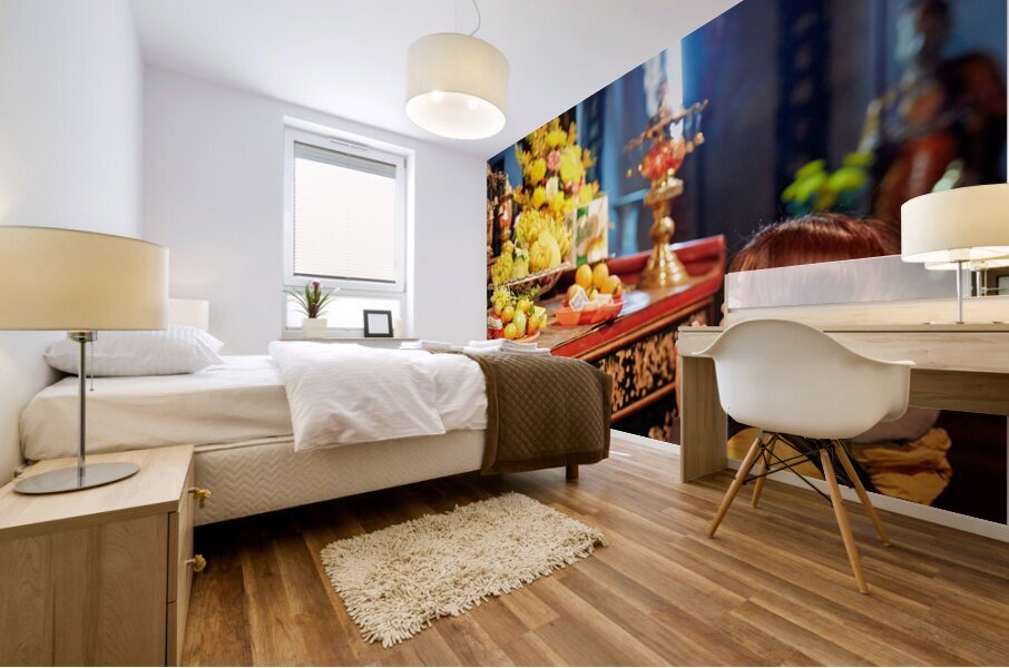 Person offers prayers at altar with fruits in Ho Chi Minh Mural print