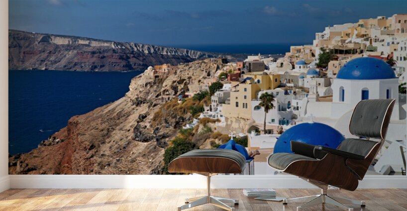 Santorinis iconic white buildings and blue domes overlooking th Wall Murals