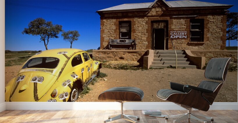 A painted yellow Beetle outside a rural stone gallery. Wall Murals