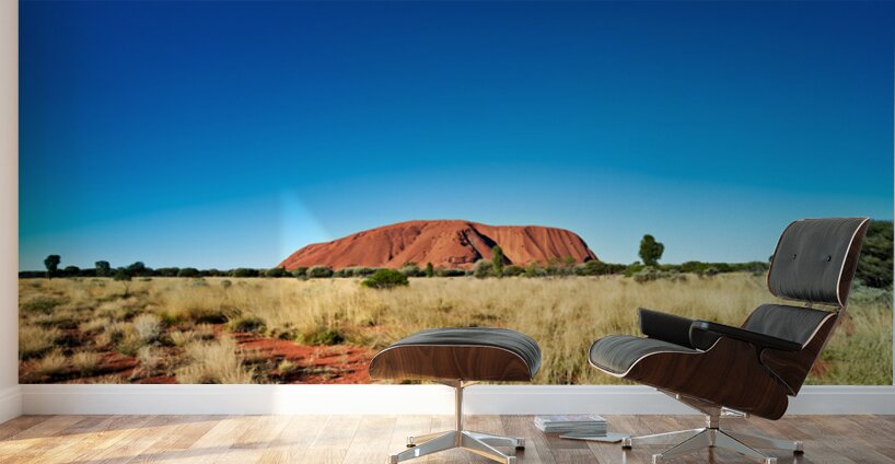 Uluru Australias iconic sandstone monolith under a clear blue Wall Murals