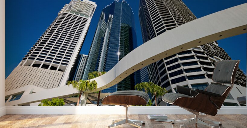 Woman walks on stairs in modern urban area with tall buildings Wall Murals