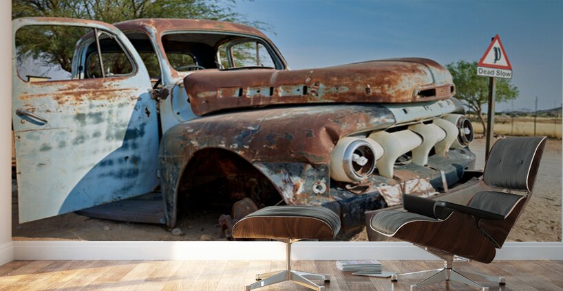 Classic car wreck in Namibias desert environment Wall Murals
