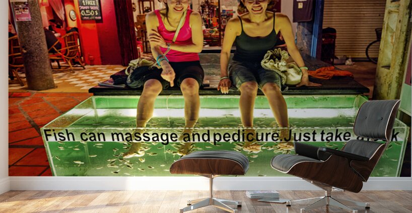 Smiling women enjoy fish foot spa. Wall Murals