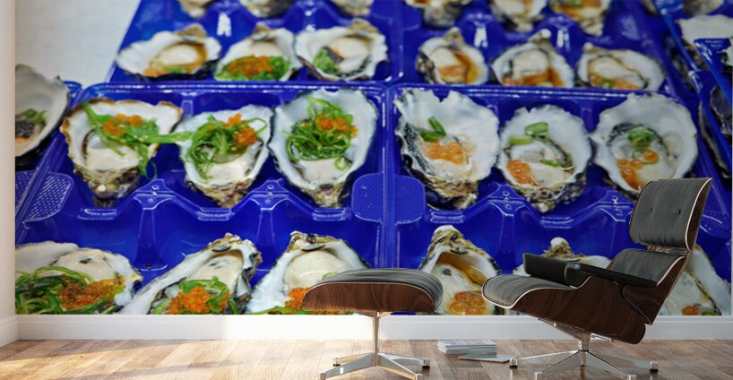 Fresh oysters with garnishes in blue trays. Wall Murals