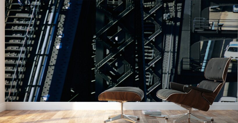 Man walks on bridge with cars below Wall Murals