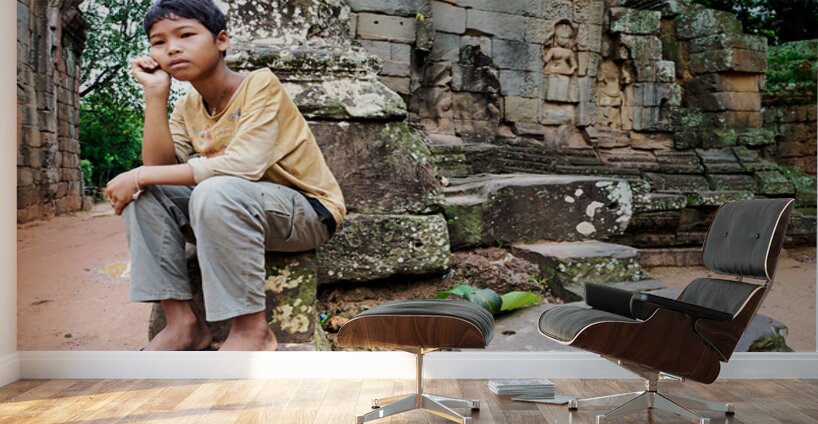 Young person sits on ancient temple ruins. Wall Murals