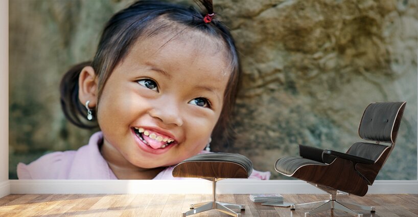Joyful young girl with a playful smile and tongue out. Wall Murals