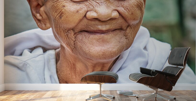 Smiling elderly Asian woman in white robe. Wall Murals