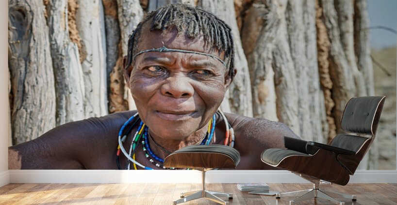 Old woman of Zemba Bantu ethnic group sits near wooden wall in N Wall Murals