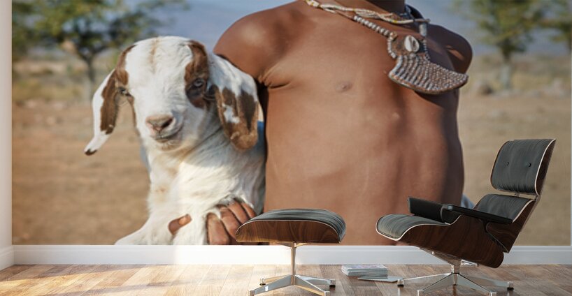 Himba child holding a goat in Kunene Region of Namibia Wall Murals