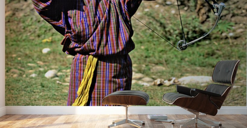 Bhutanese archer in traditional Gho aiming a compound bow. Wall Murals