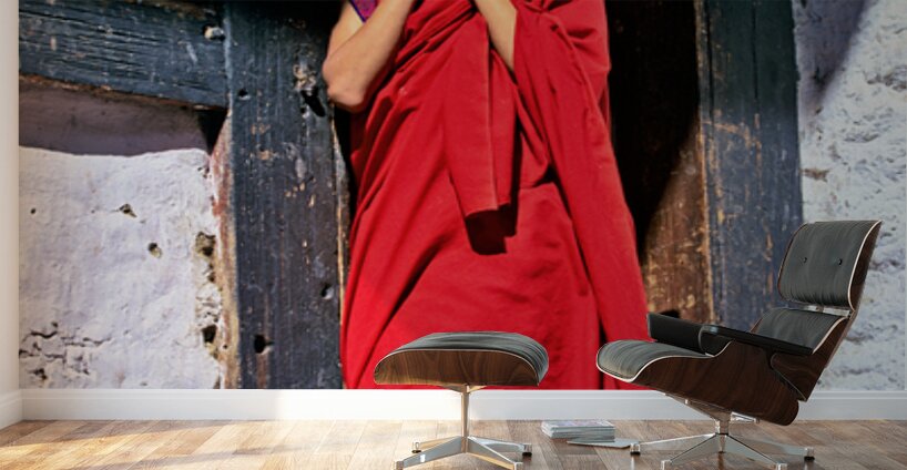 Monk in red robes on cell phone. Wall Murals