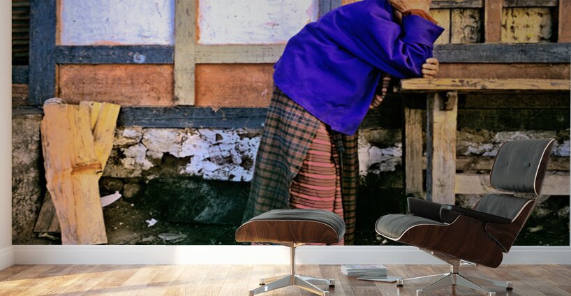 Smiling elderly woman in traditional dress leaning on wooden tab Wall Murals