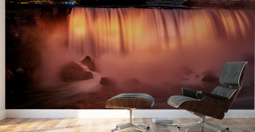 Niagara Falls illuminated orange at night. Wall Murals