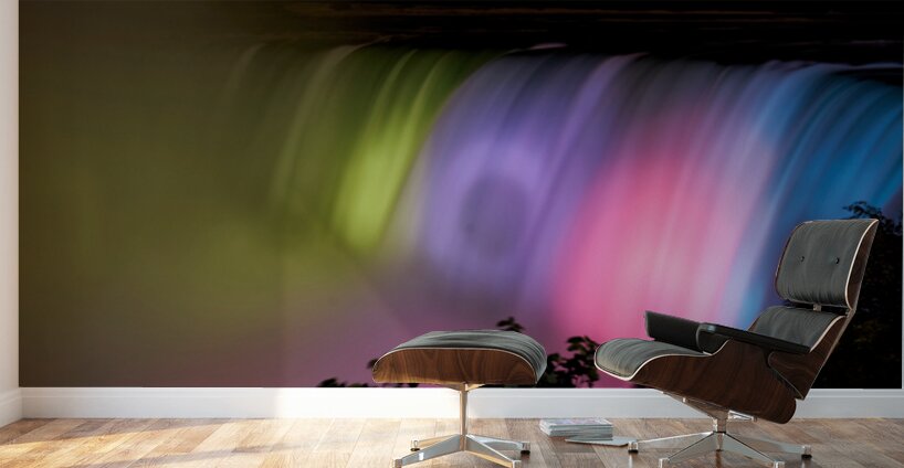 Niagara Falls illuminated with vibrant colors at night. Wall Murals
