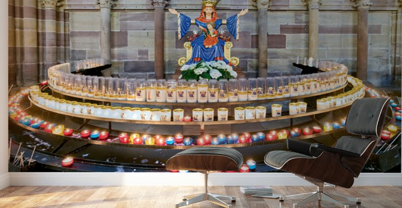 Visitors light votive candles near statue in Strasbourg Cathedra Wall Murals