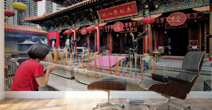 Woman prays with incense at colorful Chinese temple in Hong Kong Wall Murals