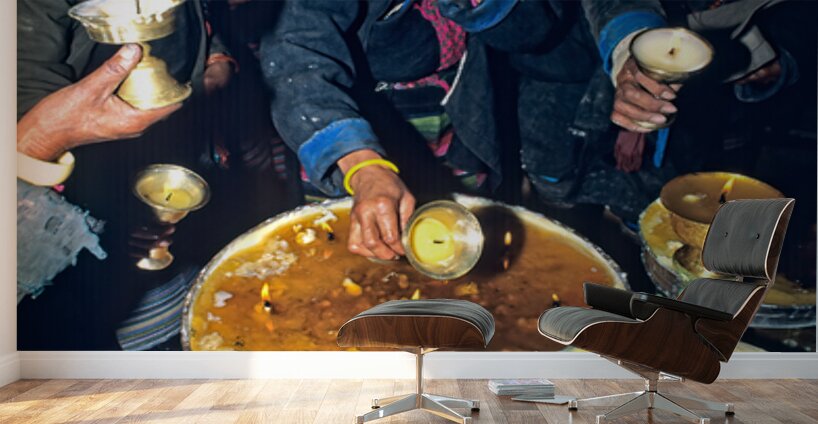 Lighting butter lamps during a ceremony in Tibet Wall Murals