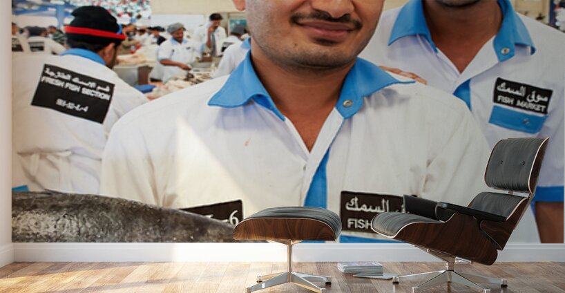 Smiling fishmongers hold fresh fish at market in Dubai UAE Wall Murals