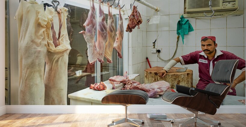 Butcher works in meat market in Dubai with hanging meat Wall Murals