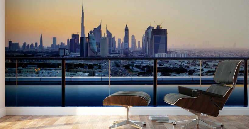 Swimming in infinity pool overlooking Dubai skyline at sunset Wall Murals