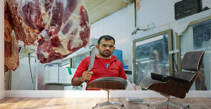 Butcher works with meat in a shop in Dubai UAE Wall Murals
