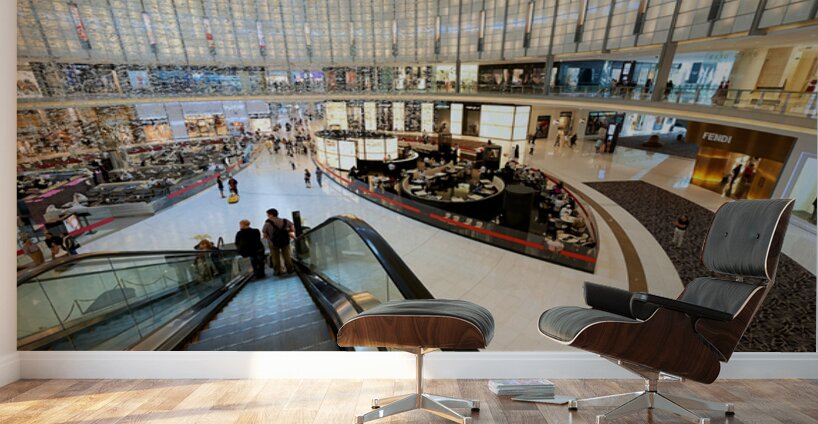 Busy shopping mall in Dubai with escalators and various stores Wall Murals