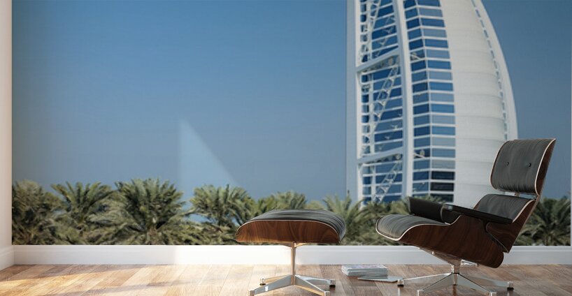 Burj Al Arab hotel stands tall by the water with palm trees Wall Murals