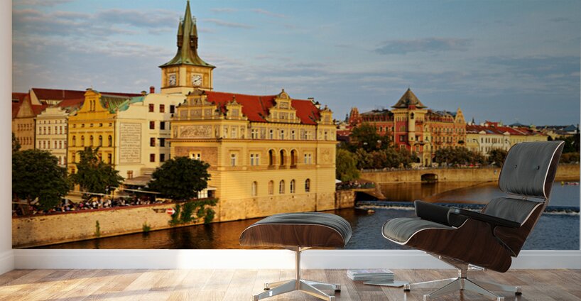 Sunset over Pragues Vltava River historic buildings and boat. Wall Murals