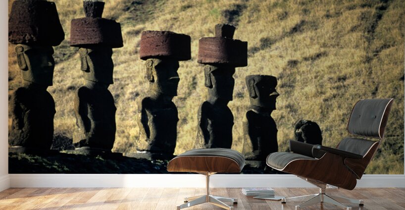 Easter Island Moai statues with red hats on a hillside. Wall Murals