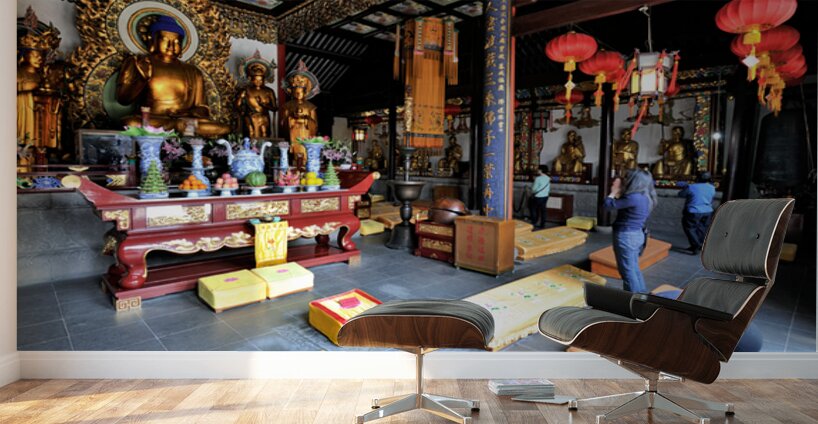 Worshippers offer prayers in a Buddhist temple in Shanghai Chin Wall Murals