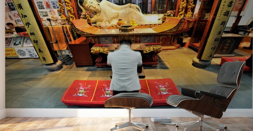 Worshipper kneels before Buddha statue in Shanghai temple Wall Murals