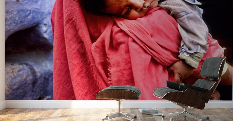 Mother carries sleeping child in India during daytime Wall Murals