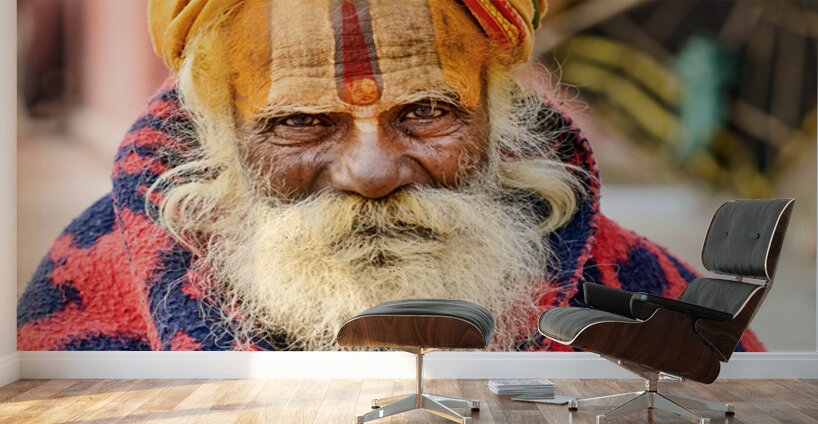 Old holy man in Varanasi wearing bright colors in Uttar Pradesh Wall Murals