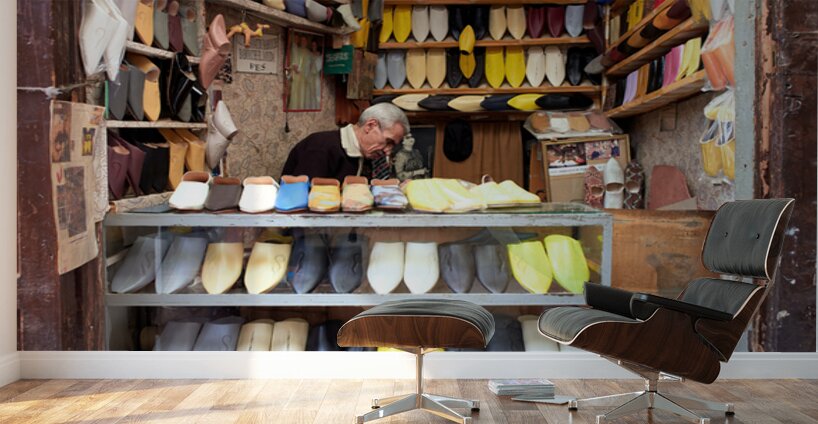 Moroccan babouches shoes in a Fez shop with a vendor Wall Murals