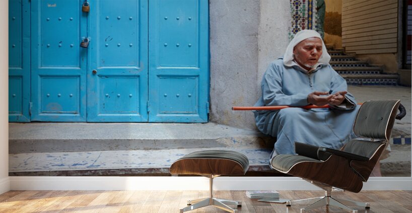 Portrait of a beggar sitting by a blue door in Fez Morocco Wall Murals