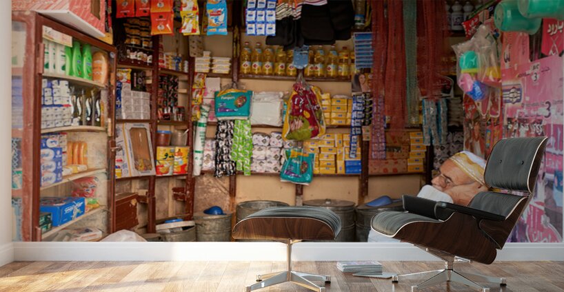 Grocer sleeping in shop in Marrakesh during afternoon hours Wall Murals