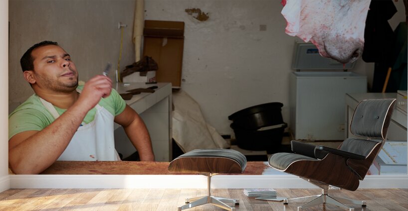 Butcher at work in Meknes souk showing fresh meat and livestock Wall Murals