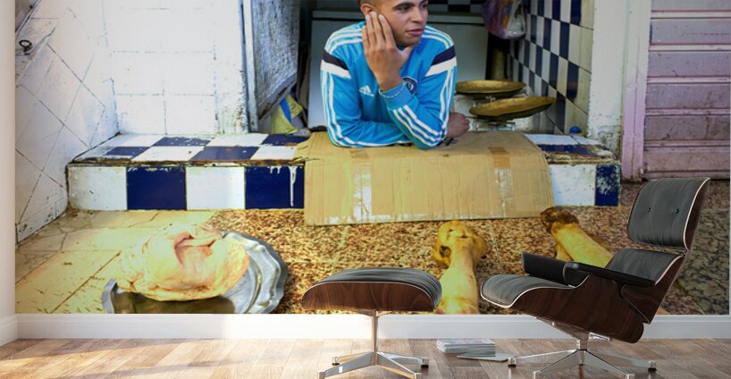 Butcher in Meknes souk interacts with customers during market ho Wall Murals