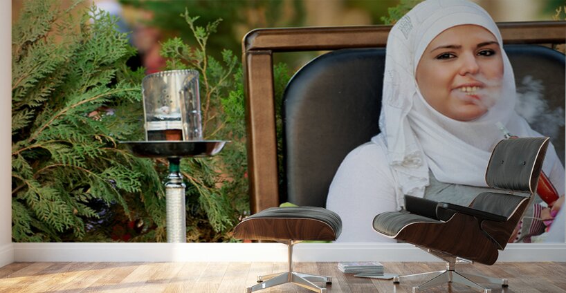 Young woman smokes hookah in outdoor cafe in Aleppo Syria Wall Murals